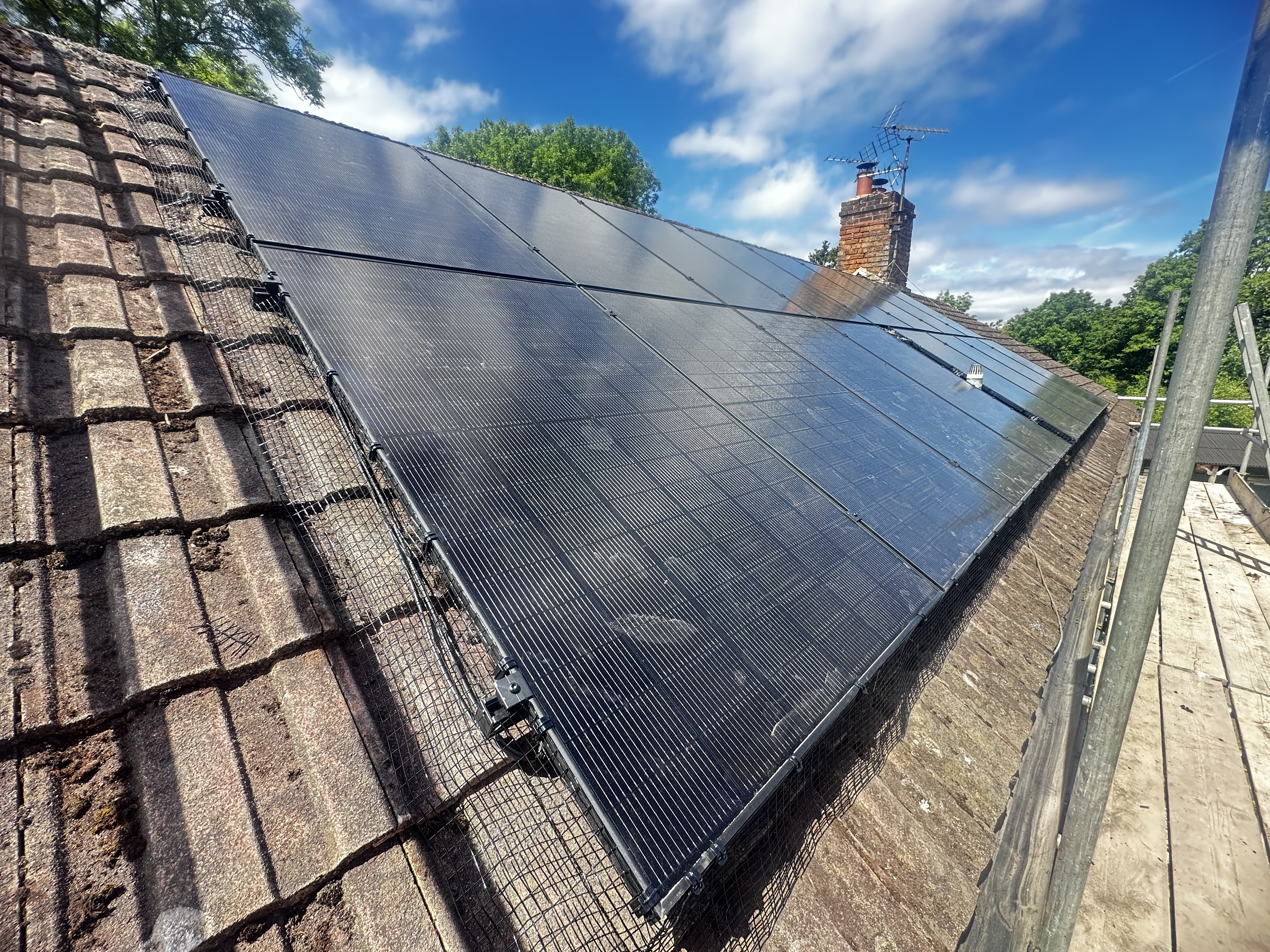 Completed black solar array on a tiled roof