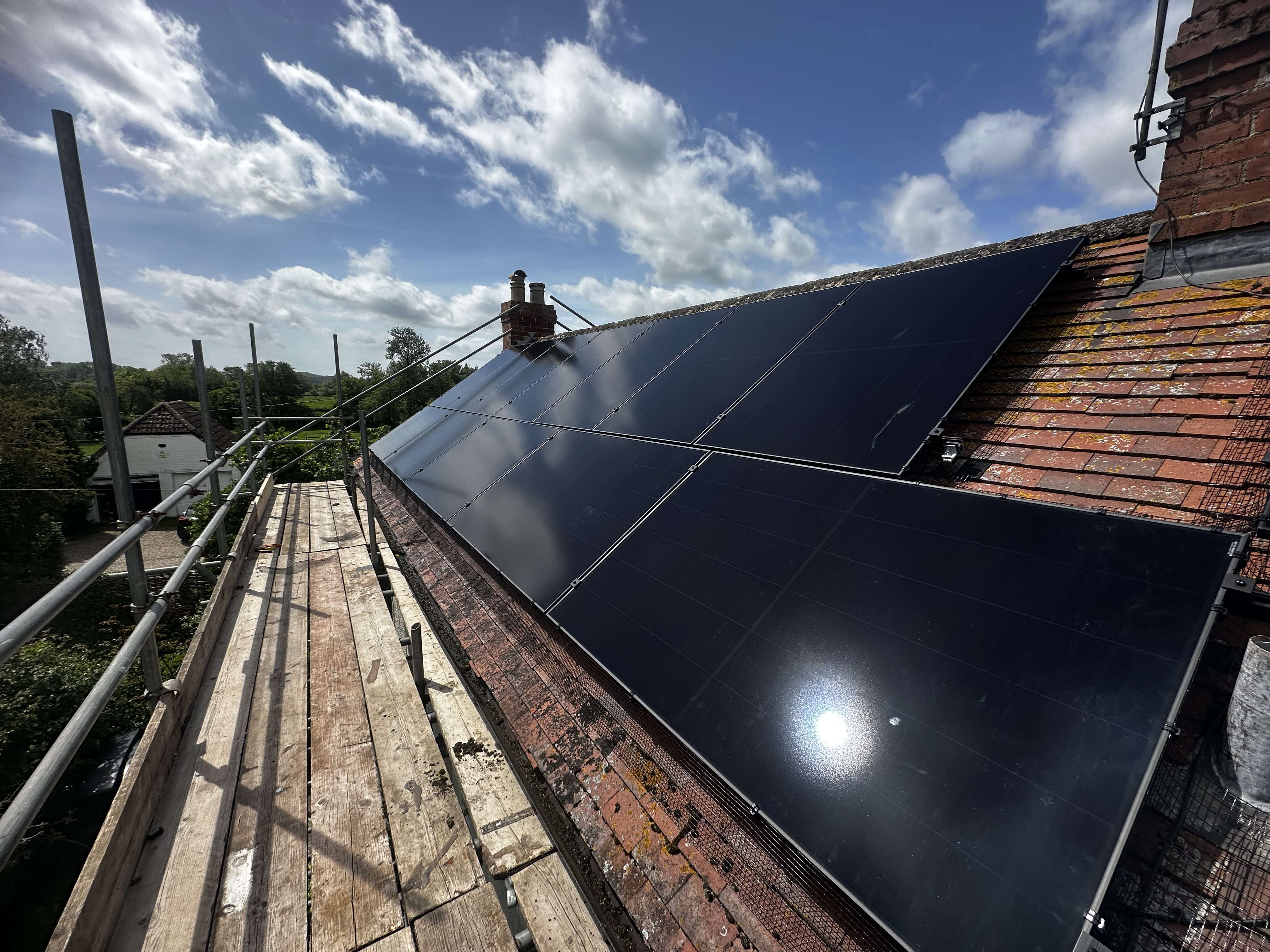 Solar panels on a tiled roof in bright sunlight