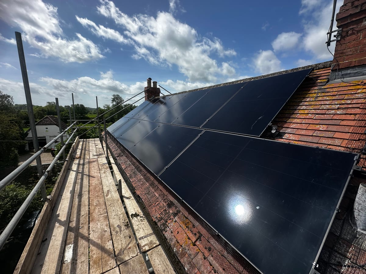 Solar panels on a tiled roof in bright sunlight